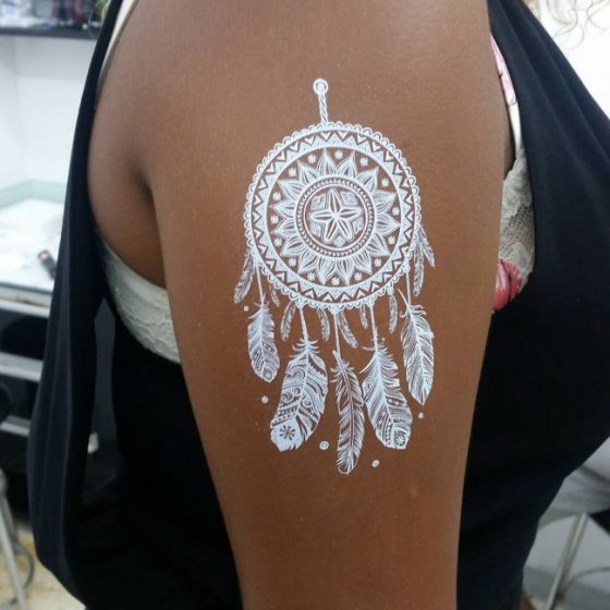 tatuaje blanco sobre piel morena